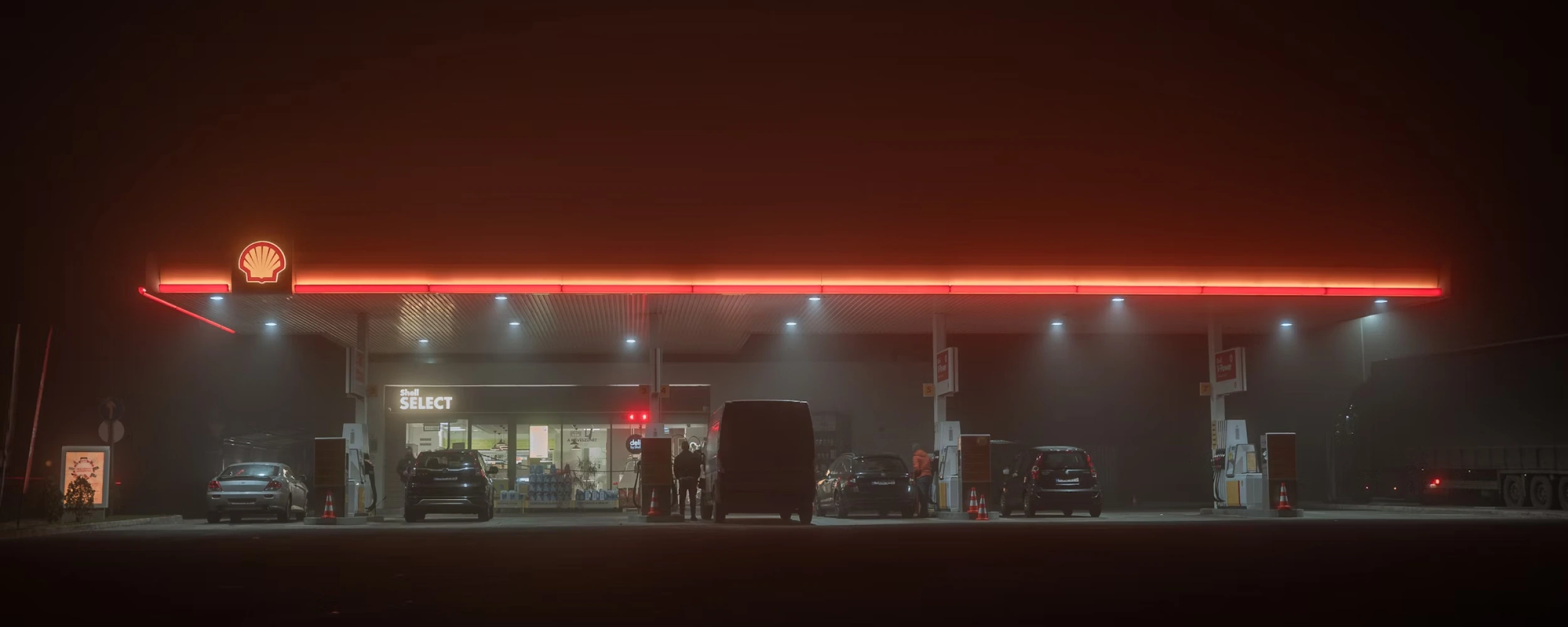 Shell petrol forecourt and petrol station at night